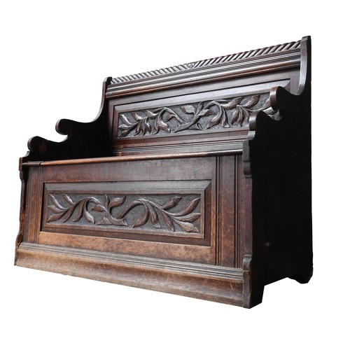 80 - A 19TH CENTURY OAK PEW / BENCH SEAT, with rope twist top rail, foliate carved back panel and lift-to... 