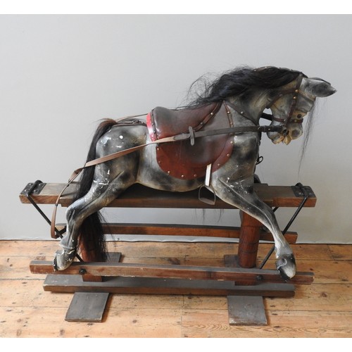 316 - A VINTAGE PAINTED PINE NURSERY ROCKING HORSE, with a dappled grey finish, on a trestle base, 110 x 1... 