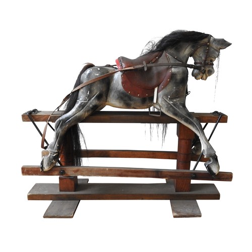 316 - A VINTAGE PAINTED PINE NURSERY ROCKING HORSE, with a dappled grey finish, on a trestle base, 110 x 1... 