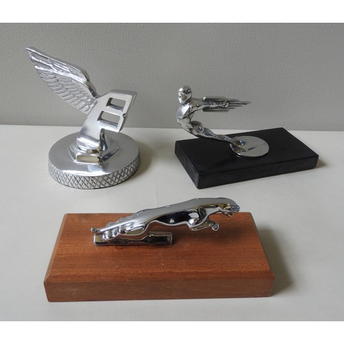 327 - THREE ASSORTED REPLICA HOOD ORNAMENTS, on plinth bases, modelled on Bentley and Jaguar mascots and a... 