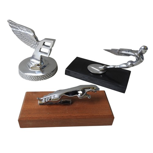 327 - THREE ASSORTED REPLICA HOOD ORNAMENTS, on plinth bases, modelled on Bentley and Jaguar mascots and a... 