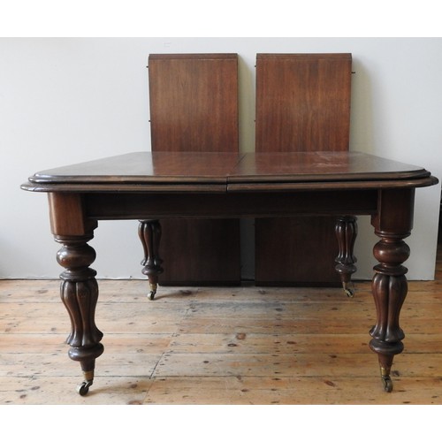 86 - A VICTORIAN MAHOGANY PULL-LEAF DINING TABLE, the top with  deep border moulding, upon ballaster lapp... 