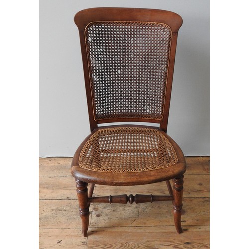 93 - A VICTORIAN MAHOGANY NURSING CHAIR WITH WICKER PANELS, with turned legs and stretcher