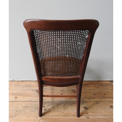 93 - A VICTORIAN MAHOGANY NURSING CHAIR WITH WICKER PANELS, with turned legs and stretcher