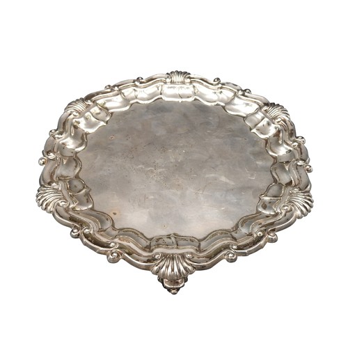 464 - A SILVER SALVER, with acanthus shell-scroll border on three scroll feet, London 1916, maker's mark G... 