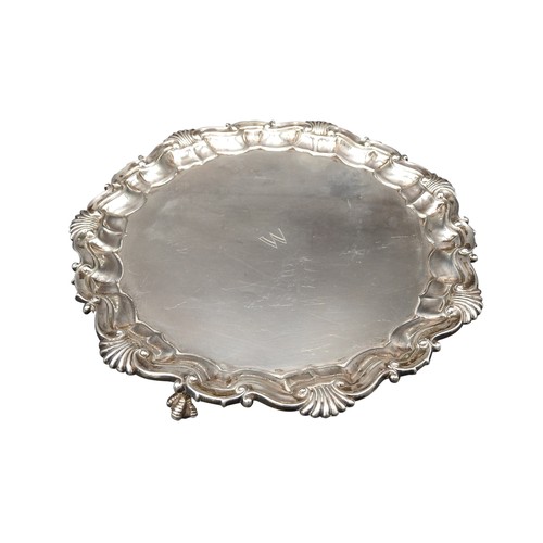 465 - A SILVER SALVER, with Acanthus shell-scroll border, on three claw feet, London 1889, maker's stamp R... 