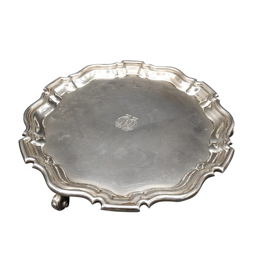 466 - A SILVER SALVER, with scroll work edge, on three scroll feet, London 1911, maker's stamp H & A.S... 