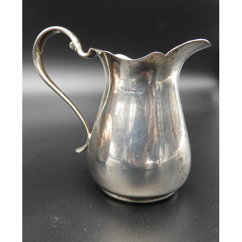 471 - A SILVER MILK JUG AND SILVER CREAM JUG, the larger milk jug of compressed globular form with reeded ... 