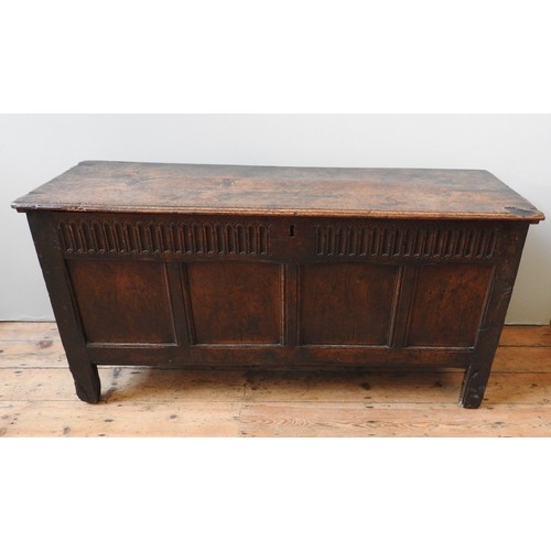 100 - AN EARLY 17TH CENTURY OAK AND WALNUT CARVED CHEST