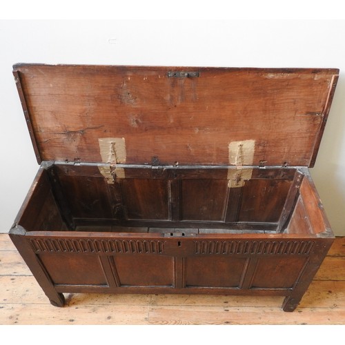 100 - AN EARLY 17TH CENTURY OAK AND WALNUT CARVED CHEST