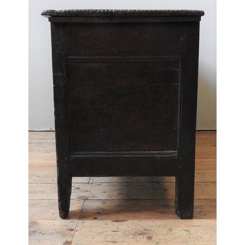 100 - AN EARLY 17TH CENTURY OAK AND WALNUT CARVED CHEST