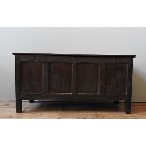 100 - AN EARLY 17TH CENTURY OAK AND WALNUT CARVED CHEST