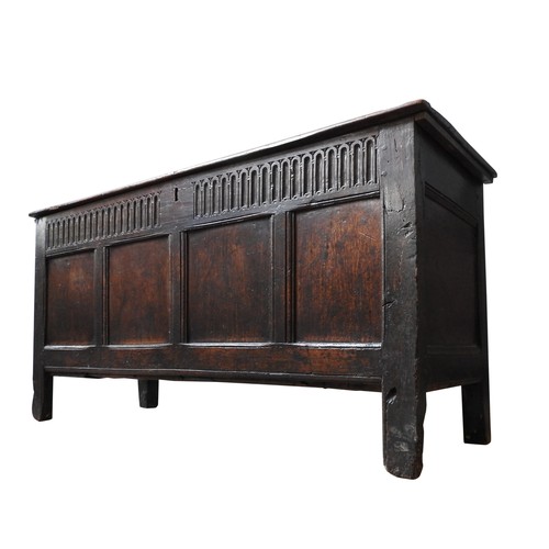 100 - AN EARLY 17TH CENTURY OAK AND WALNUT CARVED CHEST