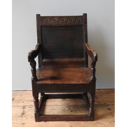 120 - A CHARLES II OAK ARMCHAIR