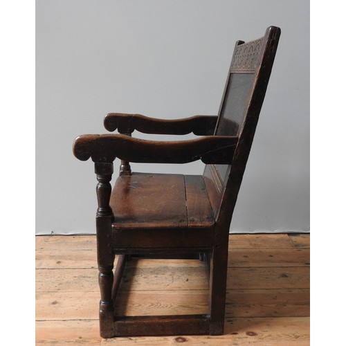 120 - A CHARLES II OAK ARMCHAIR