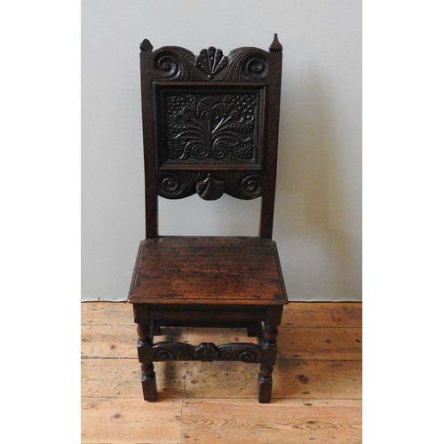 122 - A CHARLES II CARVED OAK CHAIR