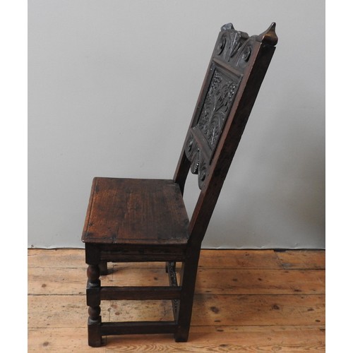 122 - A CHARLES II CARVED OAK CHAIR