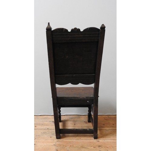 122 - A CHARLES II CARVED OAK CHAIR