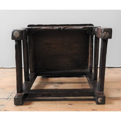 122 - A CHARLES II CARVED OAK CHAIR