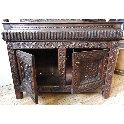 125 - AN EARLY 17TH CENTURY JOINED OAK AND CARVED LIVERY CUPBOARD, originating from Yorkshire, 157 x 145 x... 