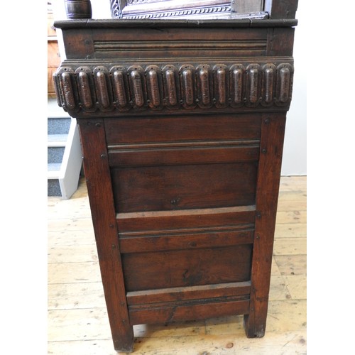 125 - AN EARLY 17TH CENTURY JOINED OAK AND CARVED LIVERY CUPBOARD, originating from Yorkshire, 157 x 145 x... 