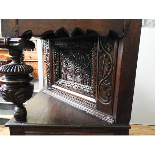 125 - AN EARLY 17TH CENTURY JOINED OAK AND CARVED LIVERY CUPBOARD, originating from Yorkshire, 157 x 145 x... 