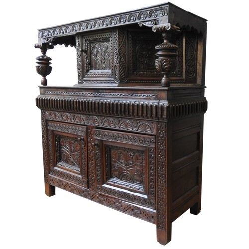 125 - AN EARLY 17TH CENTURY JOINED OAK AND CARVED LIVERY CUPBOARD, originating from Yorkshire, 157 x 145 x... 