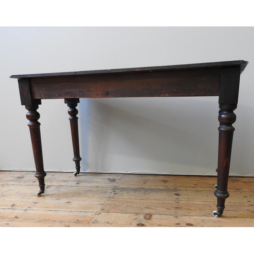 130 - A VICTORIAN MAHOGANY SIDE TABLE, on four turned baluster legs, terminating in brass cups and casters... 