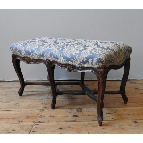 133 - A 19TH CENTURY FRENCH OAK STOOL , the upholstered seat supported by six cabriole legs, united by sha... 