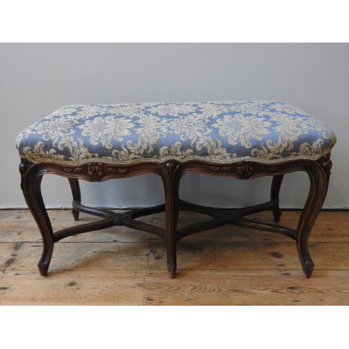 133 - A 19TH CENTURY FRENCH OAK STOOL , the upholstered seat supported by six cabriole legs, united by sha... 