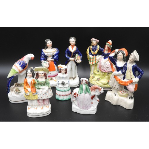 428 - A SMALL PAIR OF VICTORIAN STAFFORDSHIRE FIGURES OF A MAN AND A WOMAN CARRYING BASKETS OF FRUIT and s... 