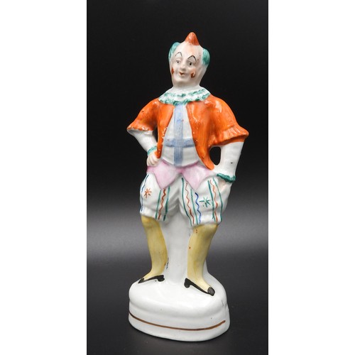 429 - A SMALL STAFFORDSHIRE FIGURE OF A CLOWN, PROBABLY DEPICTING JOSEPH GRIMALDI. 16 cms high.