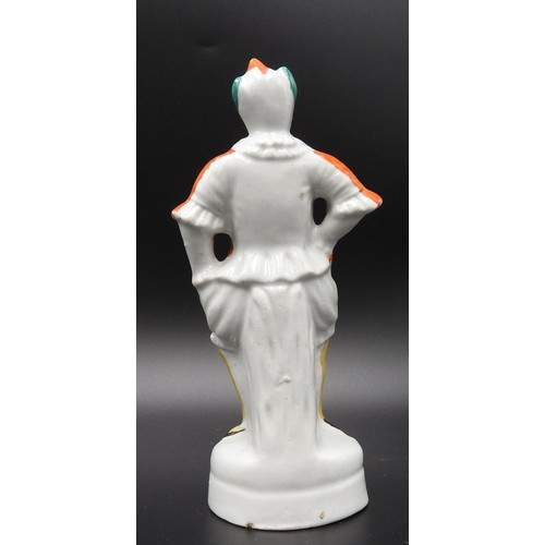 429 - A SMALL STAFFORDSHIRE FIGURE OF A CLOWN, PROBABLY DEPICTING JOSEPH GRIMALDI. 16 cms high.