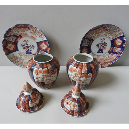 440 - A PAIR OF 19TH CENTURY IMARI COVERED VASES AND TWO DISHES, the lobed baluster vases with lids, 32 cm... 