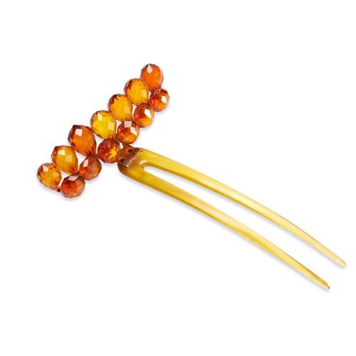 552 - AN BEADED AMBER HAIR PINSet with thirteen faceted beads hinged on a simple hair pin. One bead loose.... 