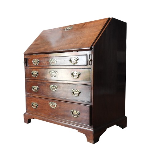 85 - A GEORGE III MAHOGANY BUREAU, the fall front over a fitted interior with three long drawers and upon... 