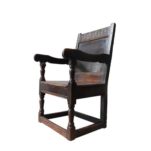 120 - A CHARLES II OAK ARMCHAIR