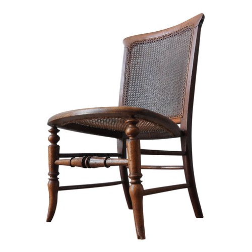 93 - A VICTORIAN MAHOGANY NURSING CHAIR WITH WICKER PANELS, with turned legs and stretcher