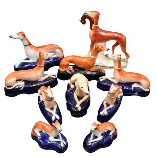 425 - A PAIR OF 19TH CENTURY STAFFORDSHIRE PEN HOLDERS IN THE FORM OF RECUMBENT GREYHOUNDS, two other pair... 