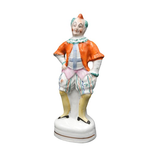 429 - A SMALL STAFFORDSHIRE FIGURE OF A CLOWN, PROBABLY DEPICTING JOSEPH GRIMALDI. 16 cms high.