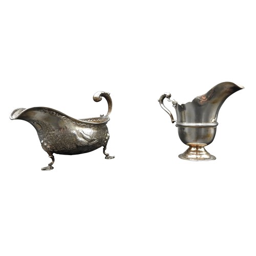 475 - AN IRISH SILVER MILK JUG AND A SILVER SAUCEBOAT, the Irish jug is Dublin 1917, stamped with a maker'... 