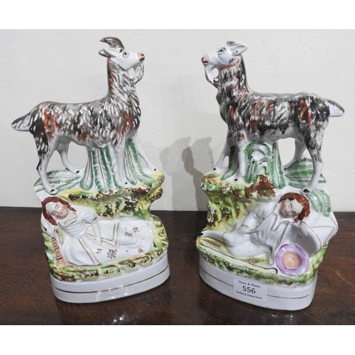 556 - A PAIR OF 19TH CENTURY STAFFORDSHIRE FIGURES DEPICTING A SLEEPING COUPLE UNDER GOATS, 28 cm high