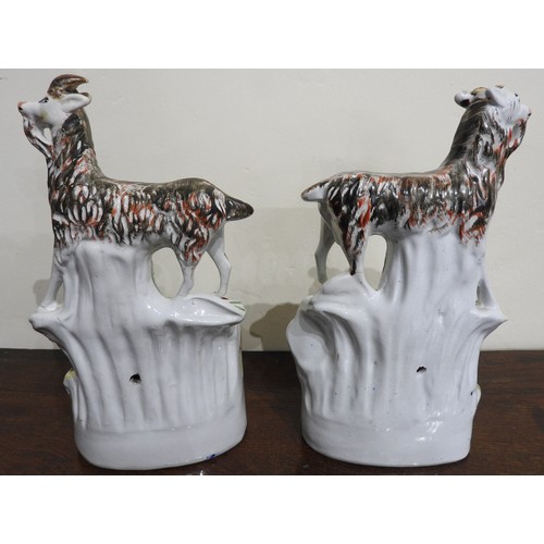 556 - A PAIR OF 19TH CENTURY STAFFORDSHIRE FIGURES DEPICTING A SLEEPING COUPLE UNDER GOATS, 28 cm high