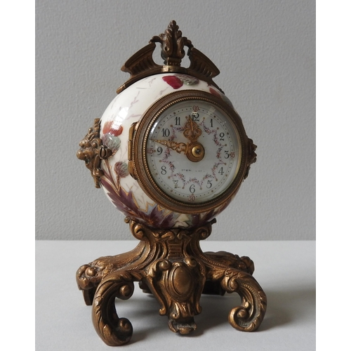 165 - A CERAMIC THISTLE PAINTED DESK CLOCK, of globular form with rococo style gilt metal mounts and base,... 