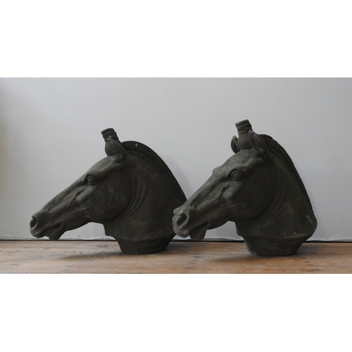 116 - A PAIR OF RECONSTITUTED STONE ORNAMENTAL HORSE'S HEAD, of weathered appearance, 56 cm high x 70 cm l... 