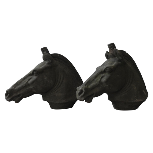 116 - A PAIR OF RECONSTITUTED STONE ORNAMENTAL HORSE'S HEAD, of weathered appearance, 56 cm high x 70 cm l... 