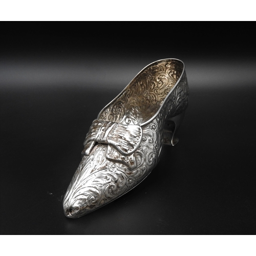 460 - A VICTORIAN SILVER SHOE ORNAMENT, with floral repousse decoration, by Nathan & Haynes, Chester 1... 