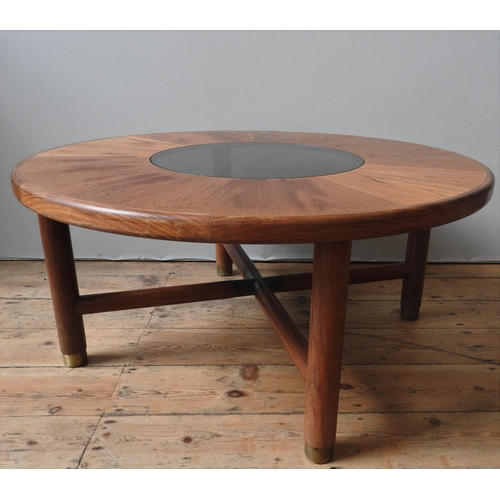 66 - A G-PLAN VINTAGE CIRCULAR COFFEE TABLE, circular teak top inset with smoked glass panel, on four leg... 