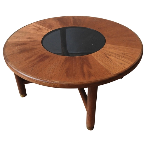 66 - A G-PLAN VINTAGE CIRCULAR COFFEE TABLE, circular teak top inset with smoked glass panel, on four leg... 