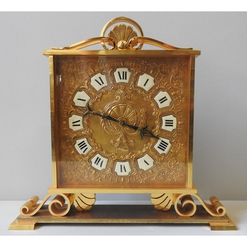 167 - A SWISS IMHOF ORNATE BRASS MANTEL CLOCK, repousse decorated square dial with enamel Roman numerals, ... 